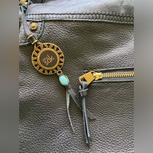 The Sak black leather and pink interior purse